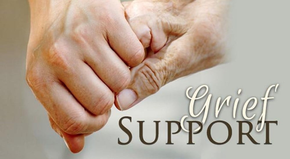 Two hands clasped in comfort with the text 'Grief Support' to illustrate pastoral care.